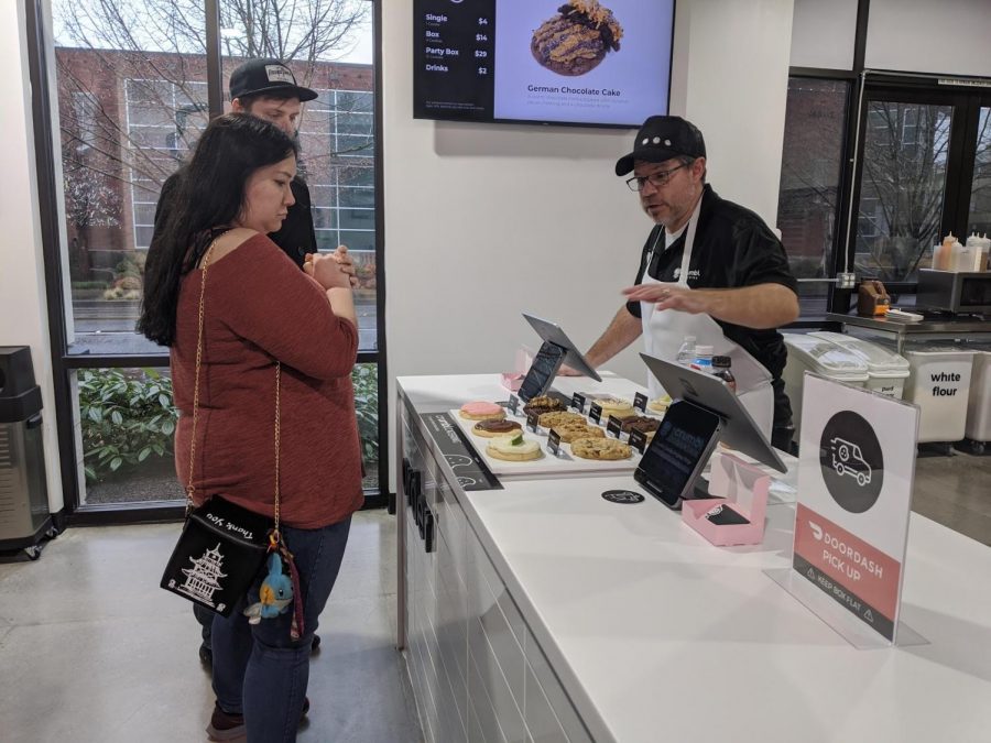 J.P. Perfili showing customers Crumbls selection of cookies