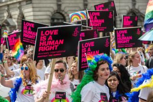 Many LGBTQ+ identifying persons at a rally to protect their rights.